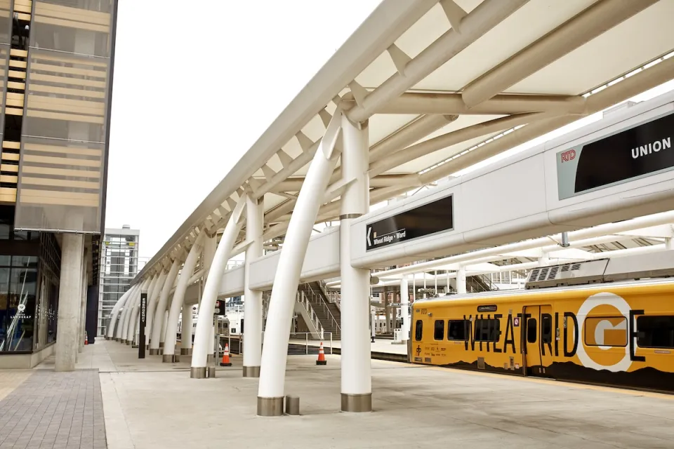 A yellow RTD train at platform at Union Station in Denver, Colorado.